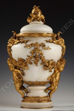 E. Cornu <br/> A marble covered urn